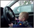 kid trying to drive a car
