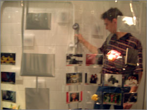 He picks up the showerhead